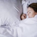 Young woman sleeping peacefully with a slight smile on her face Sleep Apnea Clinic in Ottawa