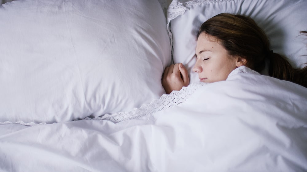 Young woman sleeping peacefully with a slight smile on her face Sleep Apnea Clinic in Ottawa