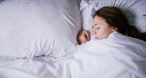 Young woman sleeping peacefully in bed