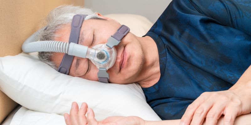man with CPAP machine on